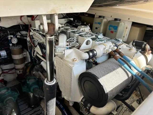 Slide: The Image of Engine compartment of a 1997 Tiara Yachts 3100 Open, showcasing mechanical components and wiring. - 26