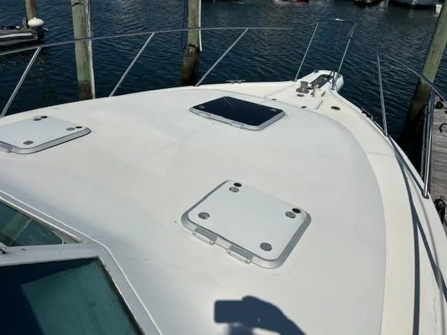 Slide: The Image of 1997 Tiara Yachts 3100 Open boat deck with hatches, docked at marina. - 3
