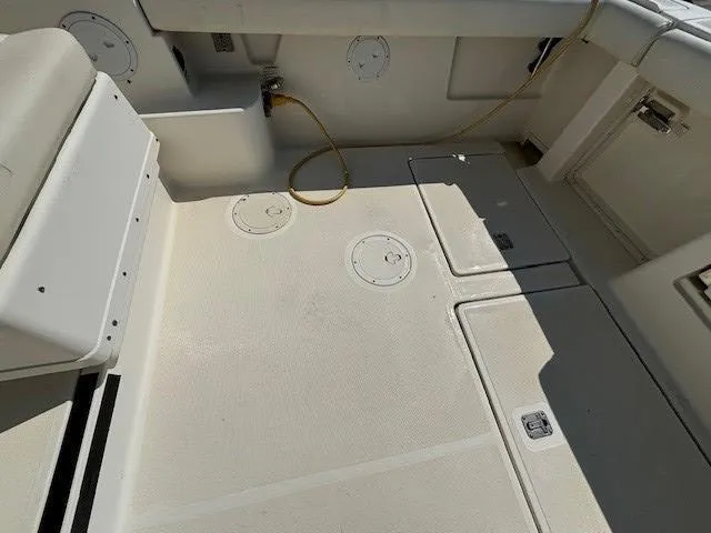 Slide: The Image of 1997 Tiara Yachts 3100 Open deck, featuring storage compartments and clean surface. - 6