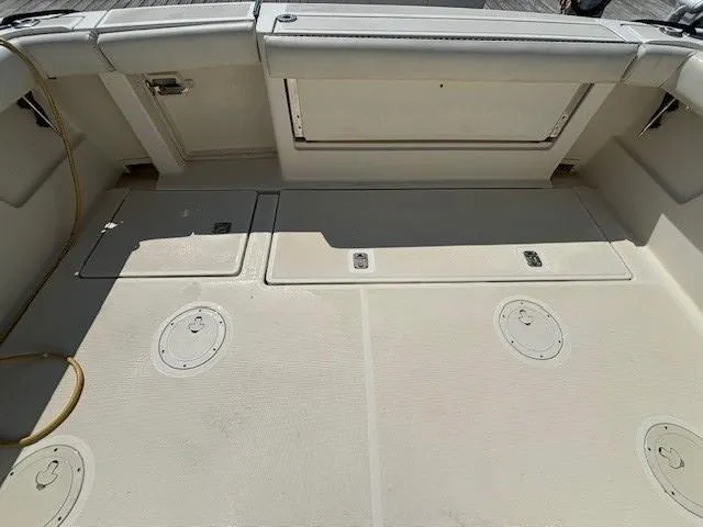 Slide: The Image of 1997 Tiara Yachts 3100 Open boat deck with storage compartments and seating. - 8