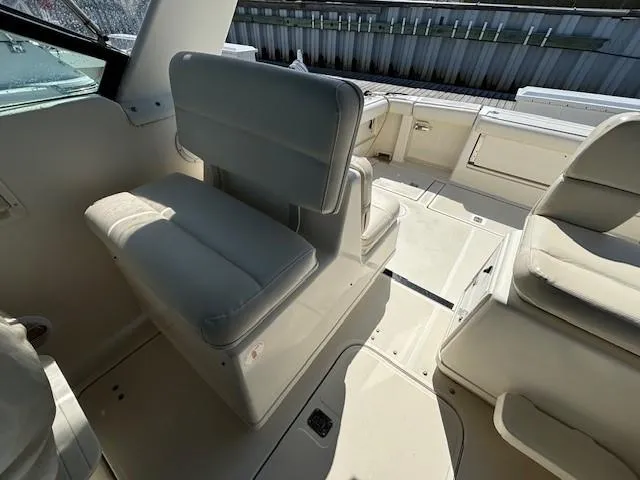 Slide: The Image of 1997 Tiara Yachts 3100 Open interior with white seating and spacious deck. - 9