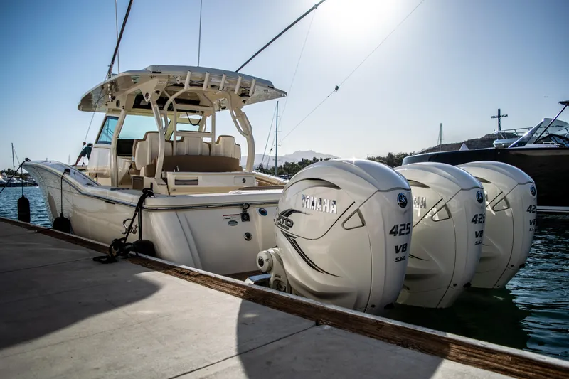 Slide: The Image of 2020 Scout 380 LXF boat with triple Yamaha 425 engines docked. - 10