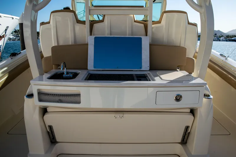 Slide: The Image of 2020 Scout 380 LXF boat interior with sink, grill, and storage compartments. - 19