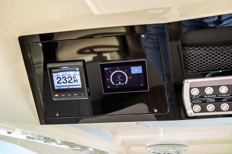 Slide: The Image of 2020 Scout 380 LXF boat dashboard with Garmin display and control panel. - 26
