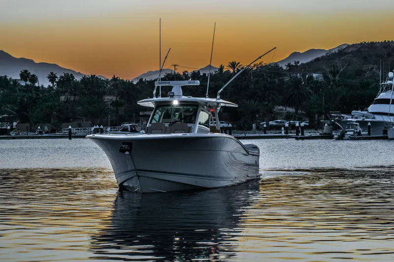 Slide: The Image of 2020 Scout 380 LXF boat at sunset on calm waters. - 3