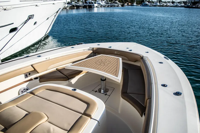 Slide: The Image of 2020 Scout 380 LXF boat with luxurious seating and table on calm water. - 33