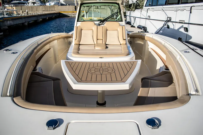 Slide: The Image of 2020 Scout 380 LXF boat with luxurious seating and table in the bow area. - 37