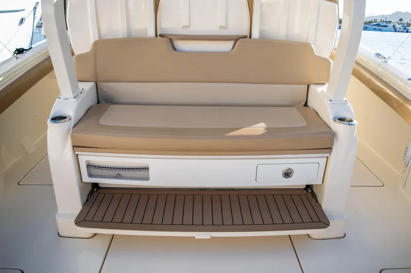 Slide: The Image of 2020 Scout 380 LXF boat seating area with storage compartment. - 43