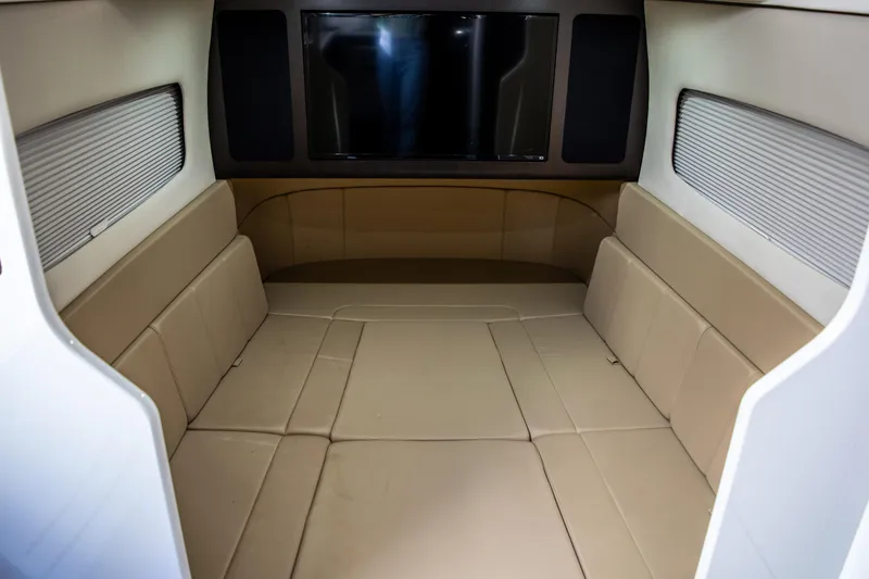 Slide: The Image of Interior cabin of 2020 Scout 380 LXF boat with beige seating and TV. - 45