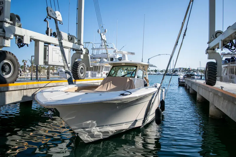 Slide: The Image of 2020 Scout 380 LXF boat docked at a marina. - 5