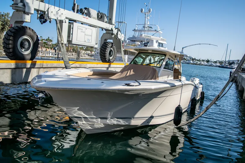 Slide: The Image of 2020 Scout 380 LXF luxury boat docked at marina. - 6