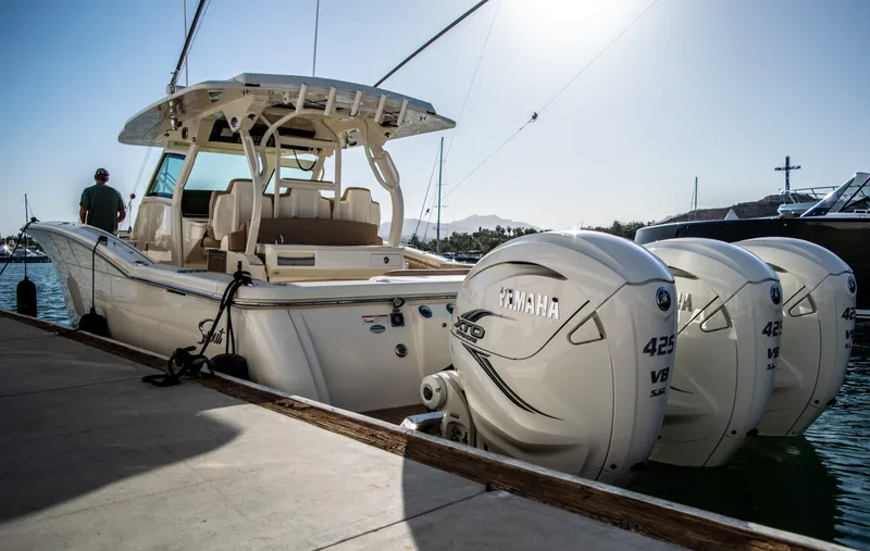 Slide: The Image of 2020 Scout 380 LXF boat docked with triple Yamaha 425 engines. - 9