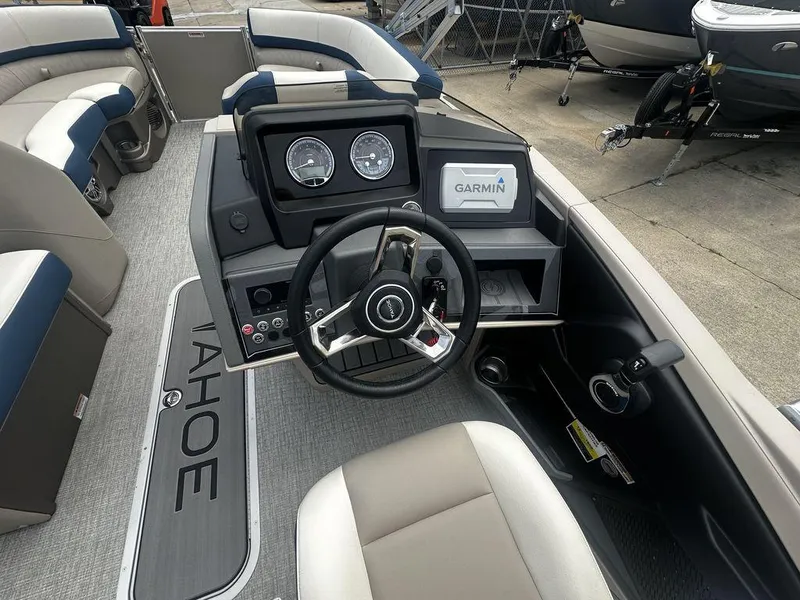 Slide: The Image of 2024 Tahoe CASCADE 2385 QL boat dashboard with Garmin navigation system. - 2