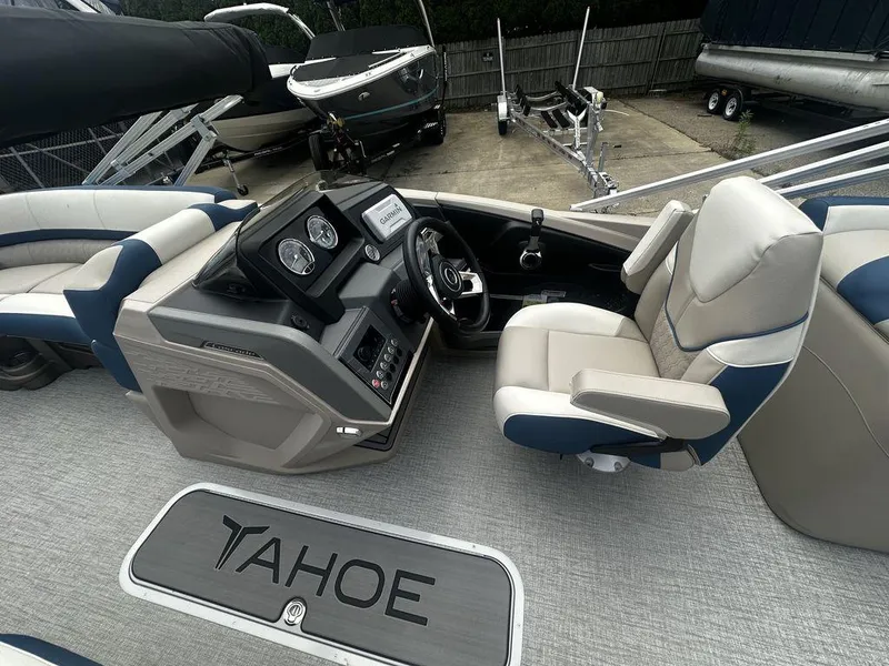 Slide: The Image of 2024 Tahoe CASCADE 2385 QL boat interior with steering console and seating. - 3