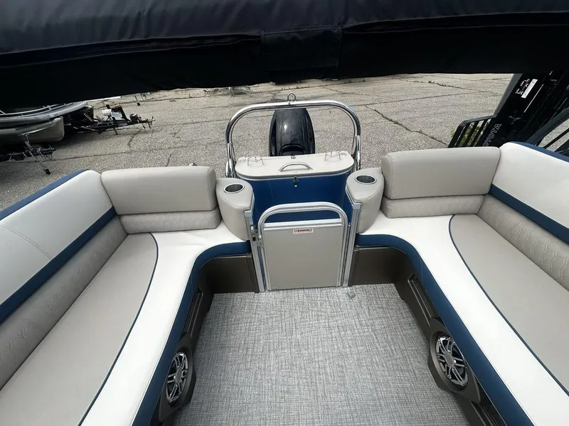 Slide: The Image of 2024 Tahoe CASCADE 2385 QL boat interior with plush seating and cup holders. - 4