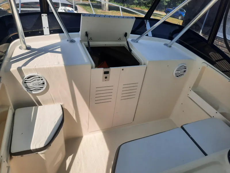 Slide: The Image of 1998 Pursuit 2800 Offshore boat interior with storage compartments and seating. - 12