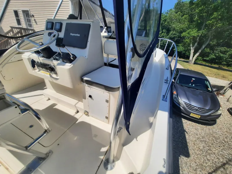 Slide: The Image of 1998 Pursuit 2800 Offshore boat cockpit with steering console and navigation equipment. - 13