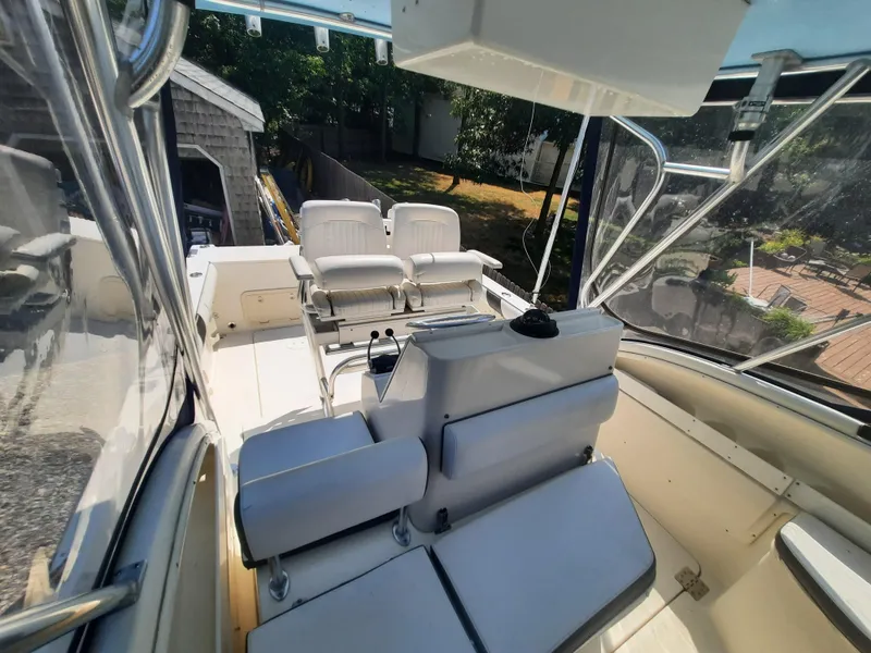 Slide: The Image of 1998 Pursuit 2800 Offshore boat interior with seating and helm station. - 16