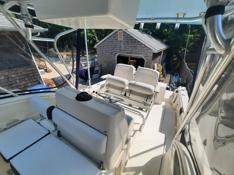 Slide: The Image of 1998 Pursuit 2800 Offshore boat interior with seating and helm station. - 17