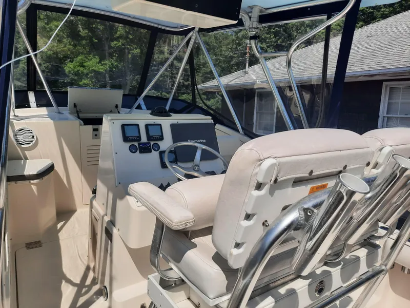 Slide: The Image of 1998 Pursuit 2800 Offshore boat cockpit with helm, seating, and navigation instruments. - 18