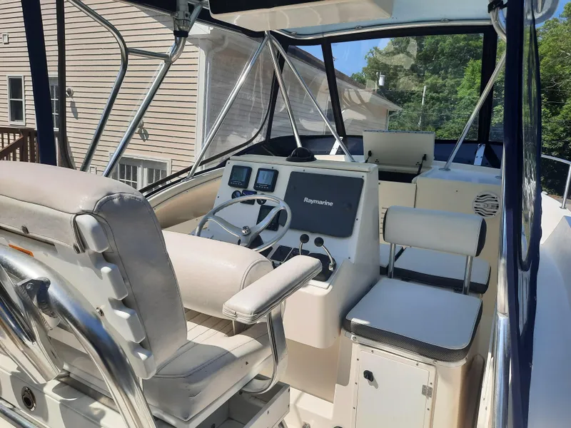 Slide: The Image of 1998 Pursuit 2800 Offshore boat cockpit with steering wheel and navigation equipment. - 19