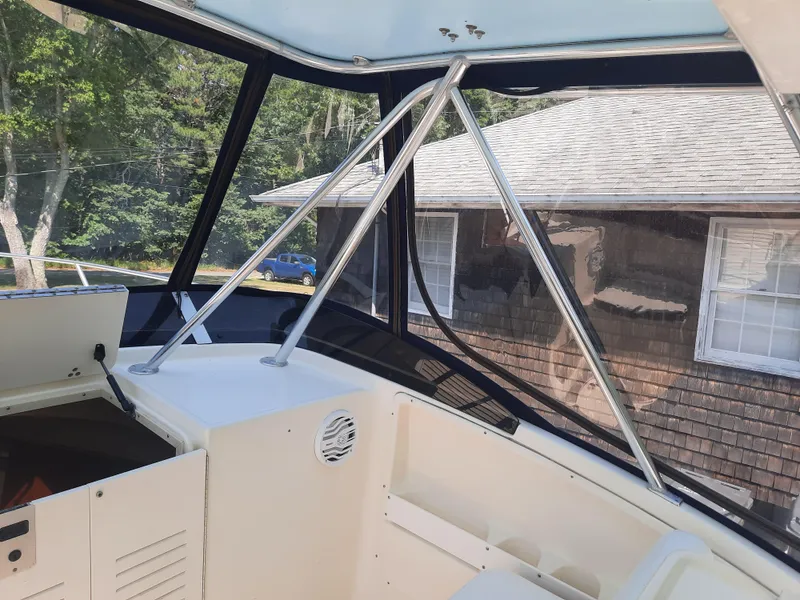 Slide: The Image of 1998 Pursuit 2800 Offshore boat interior with clear windows and sturdy frame. - 20