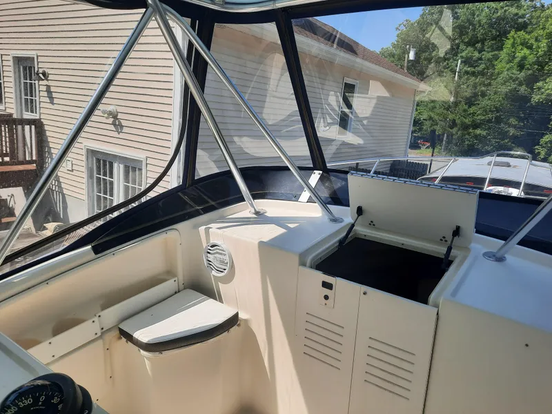 Slide: The Image of 1998 Pursuit 2800 Offshore boat interior with open storage compartments. - 22