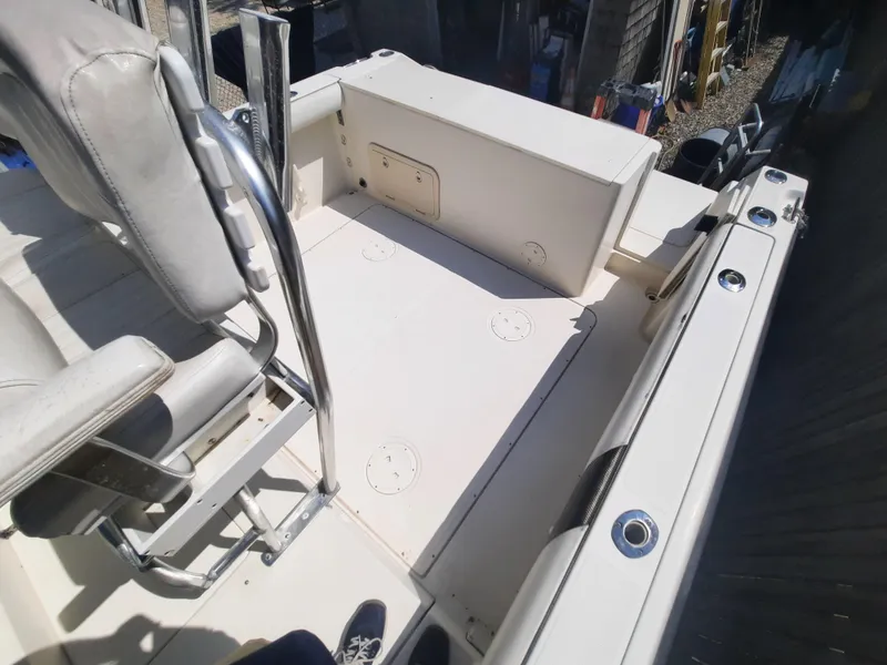 Slide: The Image of 1998 Pursuit 2800 Offshore boat deck with seating and storage compartments. - 23