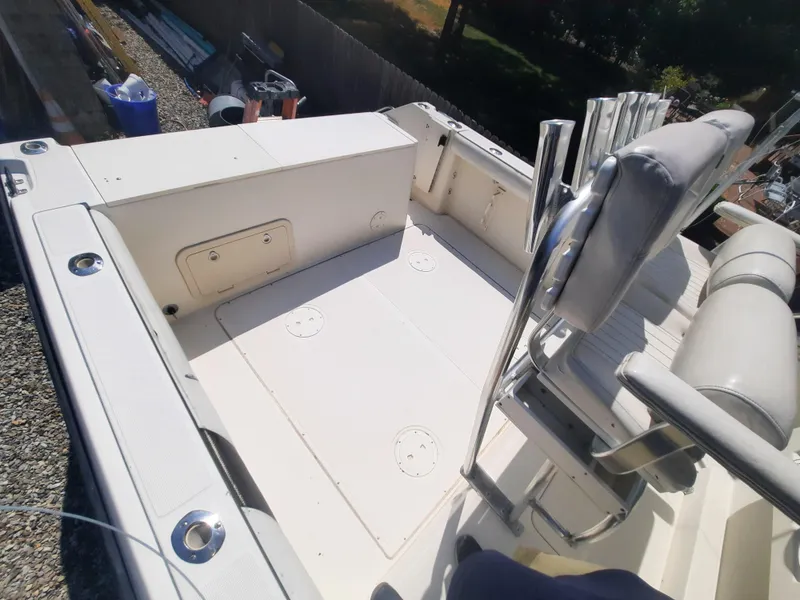 Slide: The Image of 1998 Pursuit 2800 Offshore boat deck with seating and storage compartments. - 24