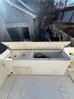 Slide: The Image of 1998 Pursuit 2800 Offshore boat with open storage compartments. - 26