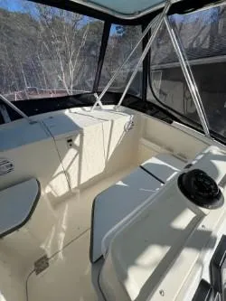 Slide: The Image of 1998 Pursuit 2800 Offshore boat interior with helm and seating area. - 27