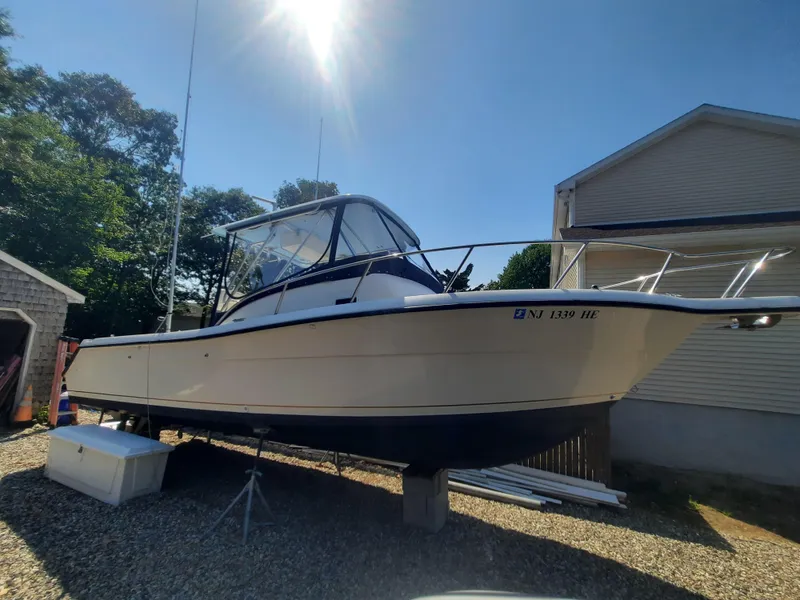 Slide: The Image of 1998 Pursuit 2800 Offshore boat on stands in a sunny yard. - 35