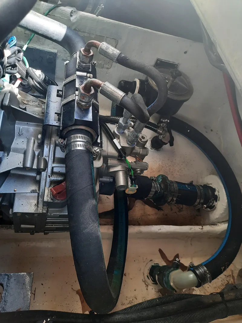 Slide: The Image of Engine compartment of a 1998 Pursuit 2800 Offshore boat showing hoses and mechanical components. - 40