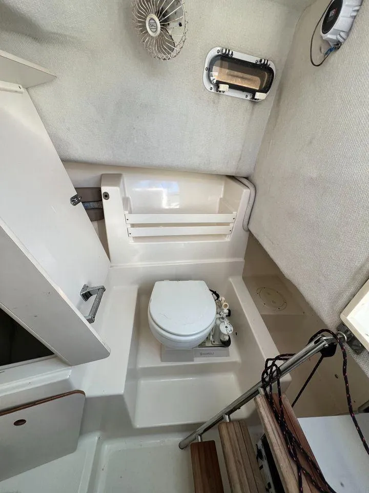 Slide: The Image of 1998 Pursuit 2800 Offshore boat bathroom with toilet and ventilation. - 42