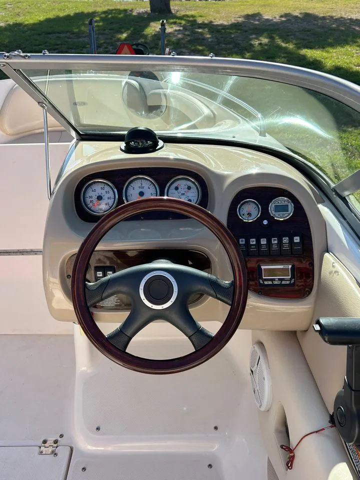 Slide: The Image of 2006 Chaparral 210 SSi boat dashboard with steering wheel and gauges. - 15