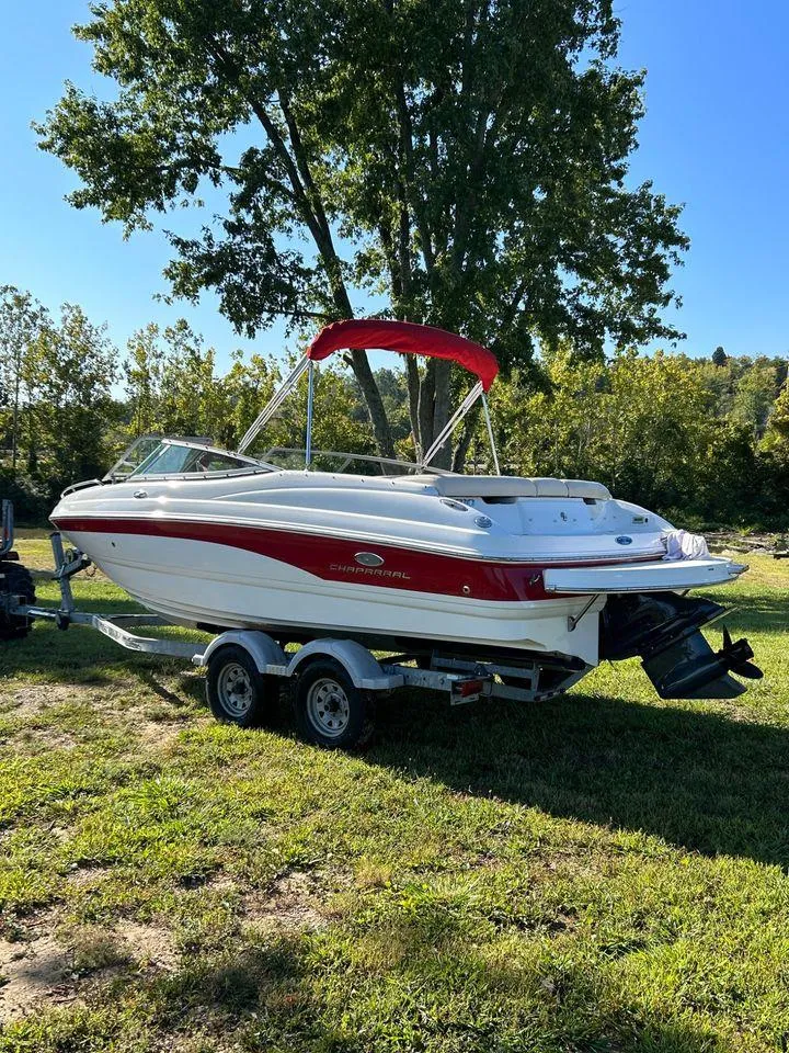 Slide: The Image of 2006 Chaparral 210 SSi boat with red accents on a trailer. - 21