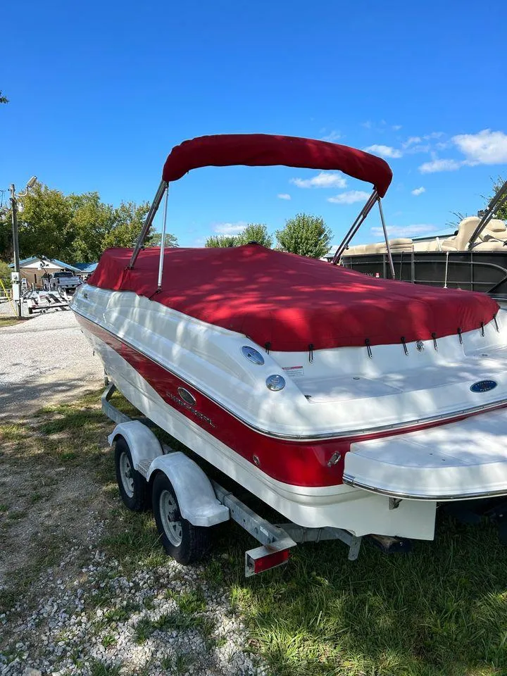 Slide: The Image of 2006 Chaparral 210 SSi boat with red cover on a trailer. - 6