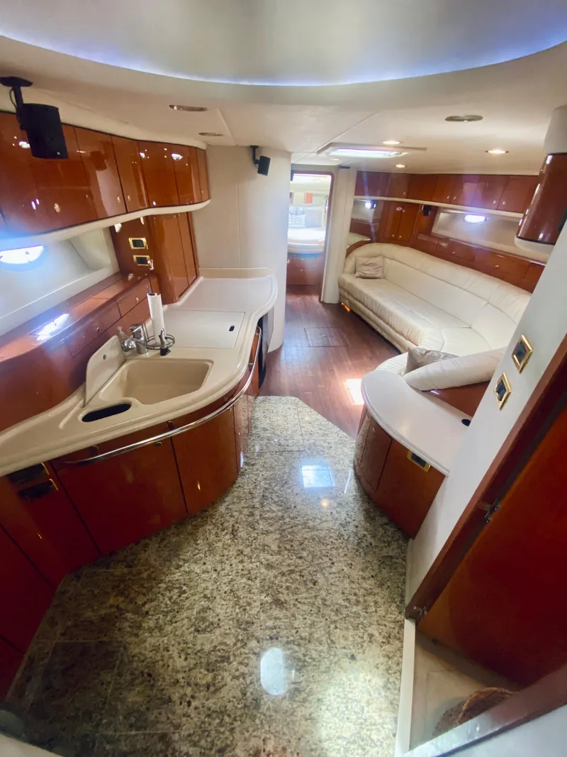 Slide: The Image of Luxurious interior of 2001 Sea Ray 540 Sundancer yacht with modern kitchen and seating area. - 10