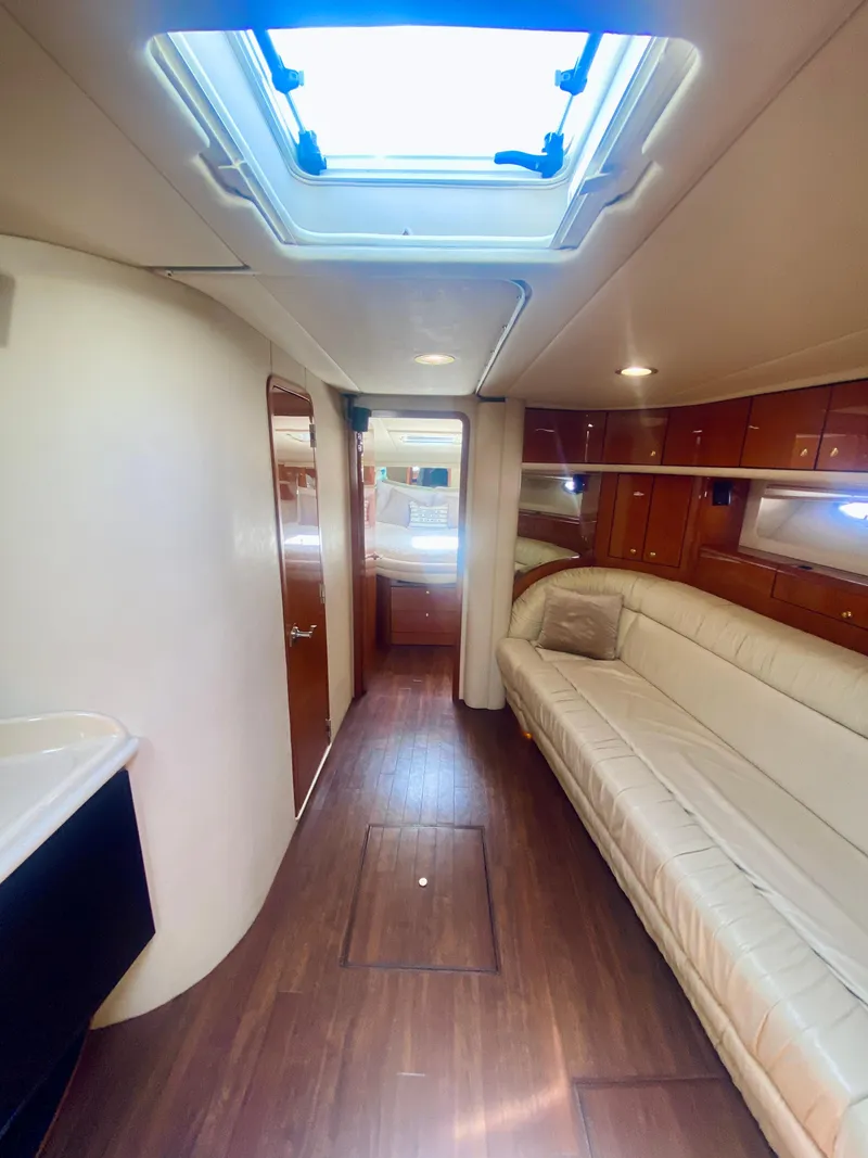 Slide: The Image of Interior of 2001 Sea Ray 540 Sundancer yacht with skylight and white leather seating. - 16