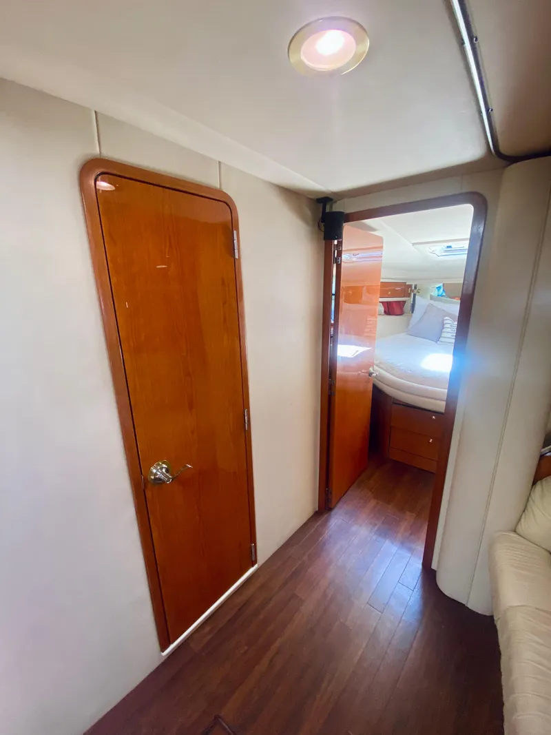 Slide: The Image of Interior hallway of 2001 Sea Ray 540 Sundancer yacht with wooden doors. - 17