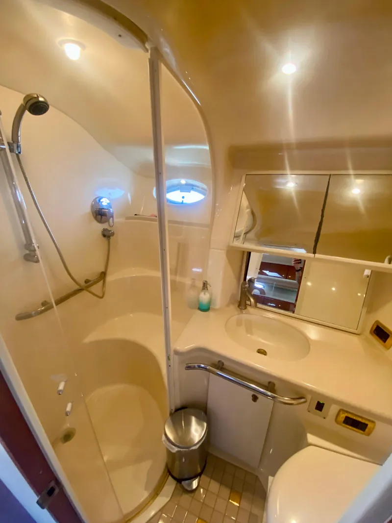 Slide: The Image of 2001 Sea Ray 540 Sundancer bathroom with shower, sink, and mirror. - 18