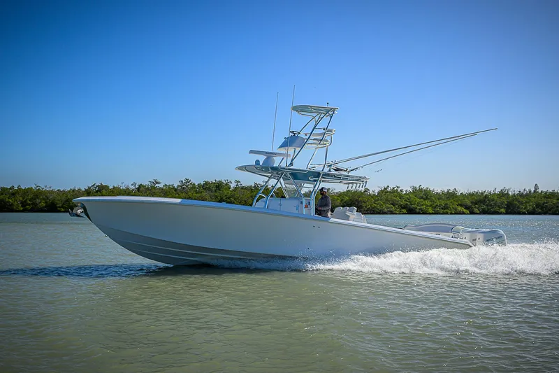 Slide: The Image of 2019 Bahama 41 boat cruising on calm water under clear blue sky. - 17