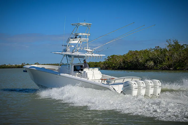Slide: The Image of 2019 Bahama 41 boat cruising on water with multiple outboard engines. - 18