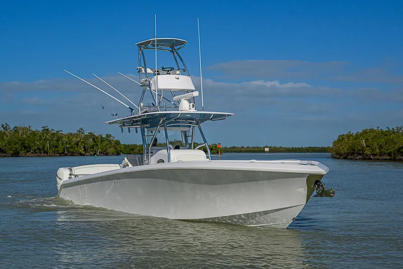 Slide: The Image of 2019 Bahama 41 boat cruising on a calm waterway under a clear blue sky. - 2