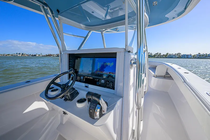 Slide: The Image of 2019 Bahama 41 boat cockpit with advanced navigation system and steering wheel on open water. - 30