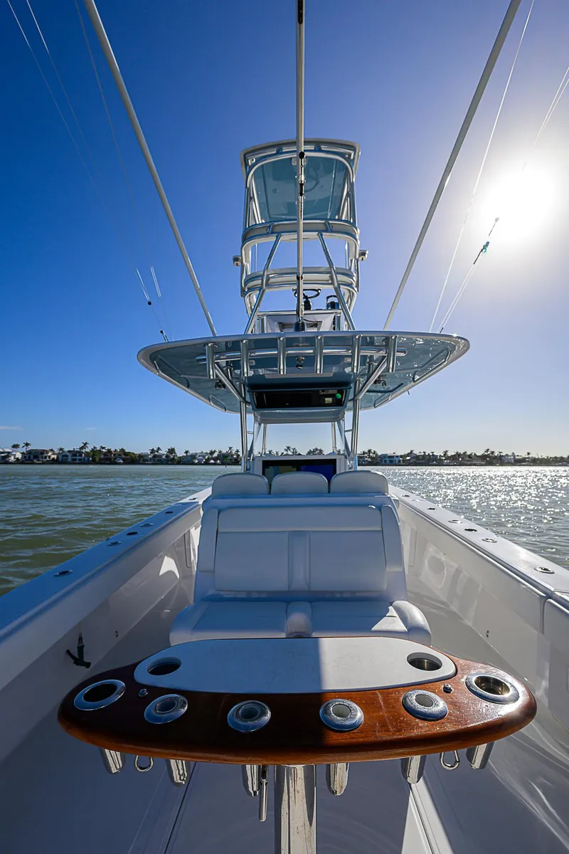 Slide: The Image of 2019 Bahama 41 boat with tower, rod holders, and sunny ocean backdrop. - 37