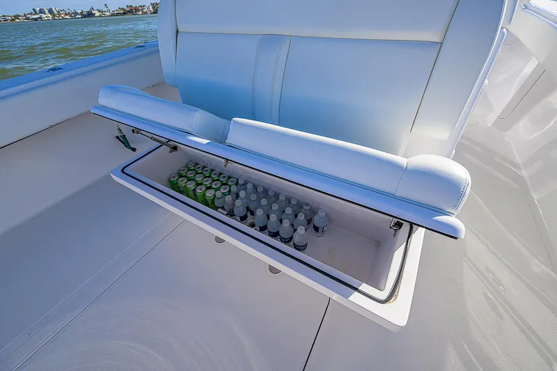 Slide: The Image of 2019 Bahama 41 boat seat with built-in cooler, stocked with drinks. - 39