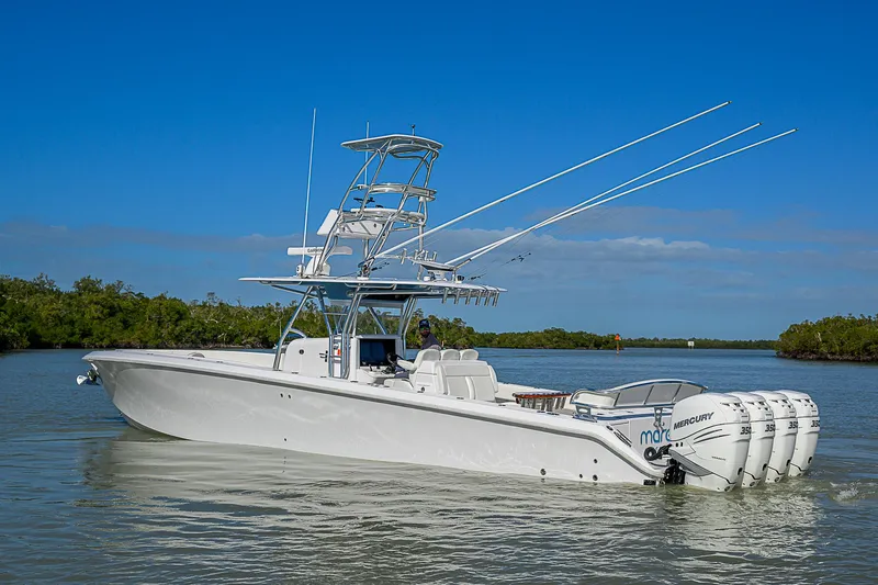 Slide: The Image of 2019 Bahama 41 boat with multiple outboard engines on calm water. - 4