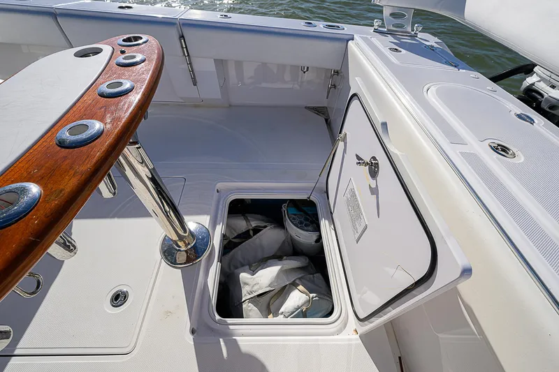 Slide: The Image of 2019 Bahama 41 boat deck with open storage compartment and fishing rod holders. - 42