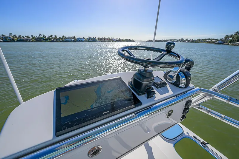 Slide: The Image of Control panel of a 2019 Bahama 41 boat with steering wheel and navigation screen. - 45